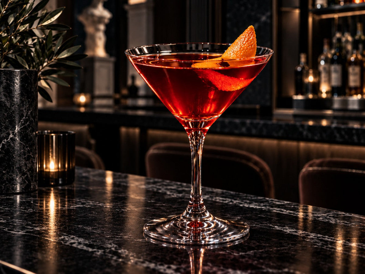 Boulevardier in a martini glass with orange twist