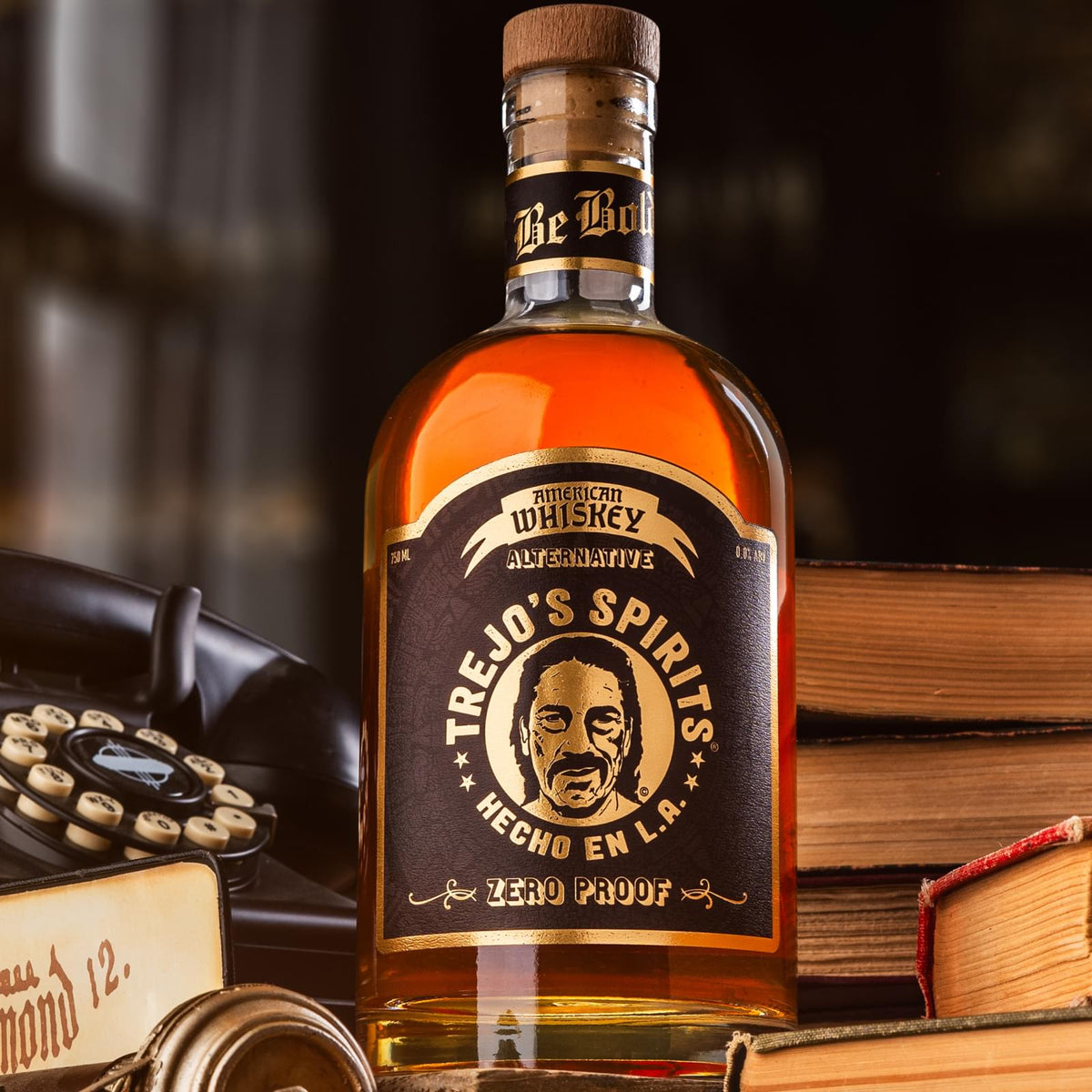 American Whiskey Alternative bottle beside old books and a rotary phone