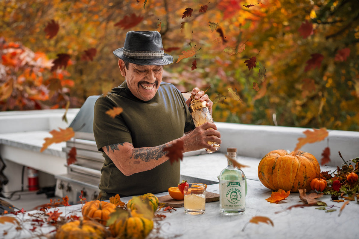 Danny Trejo mixing a non-alcoholic tequila cocktail outdoors in fall